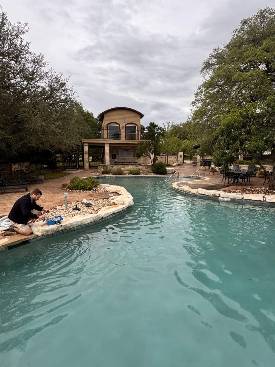 Belle Pools technician servicing a residential pool