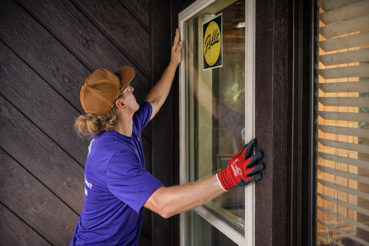 Belle technician installing a window at a home exterior
